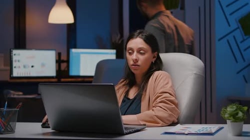 Woman Working Late in Office at Laptop