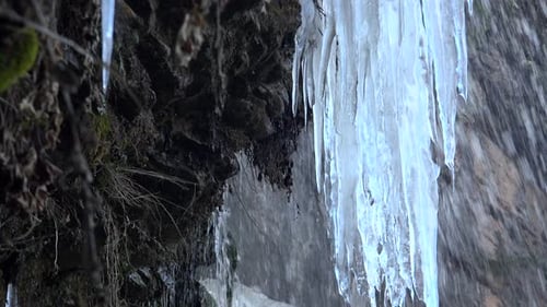 Iced Waterfall in Winter on Rocky Wall