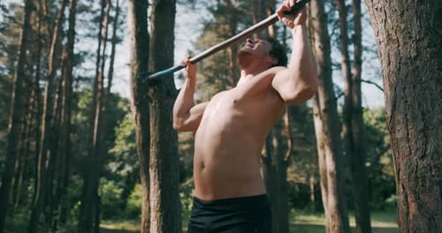 Strong Man Performing Exercises on the Uneven Bars, Sport and Healthy Lifestyle. Close Up of Strong