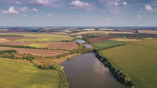 Aerial Hyperlapse of Rural Fields and Green Landscapes During Sunny Day