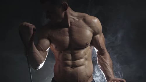 Muscular Man Working Out Biceps with Resistance Band