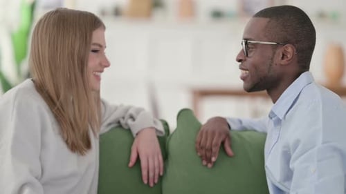 Woman and Man Talking on a Couch