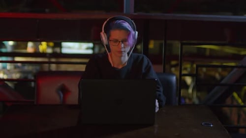 Female Programmer Using PC in Bar