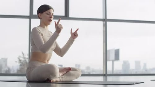 Woman Does Yoga Workout in Urban Apartment