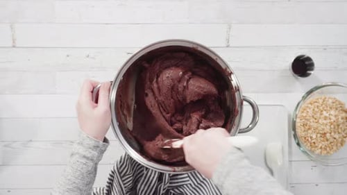 Flat lay. Step by step. Melting chocolate chips in the cooking pot to make macadamia nut fudge.