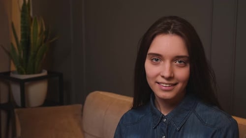 Confident Smiling Young Woman Looking at Camera Standing at Home Office