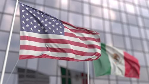 Flags of the USA and Mexico in Front of a Modern Skyscraper