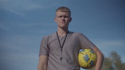 Soccer Referee with Red Card Sending Off Player