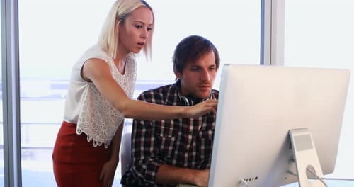 Team Discussing Project at Office Desktop Computer