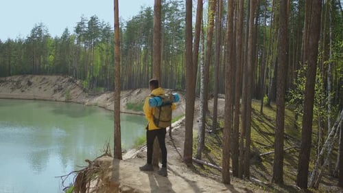 Back View of One Black Man Looking on Mountain and Lake