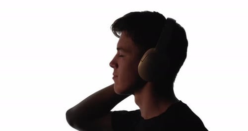 Silhouette of Person Listening to Music with Headphones