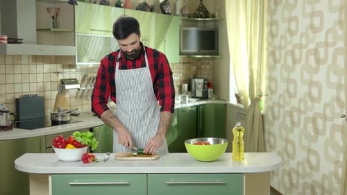 Man Cuts Cucumber