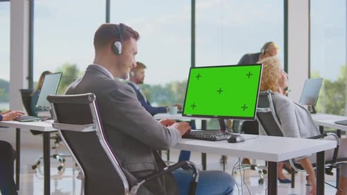 Modern Office Workers at Desks with Chroma Key Screen
