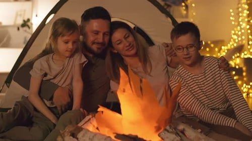 Loving Family Embracing near Artificial Bonfire