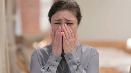 Distraught Woman Crying and Covering Her Face