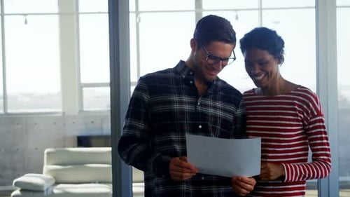 Executives having discussion over document in office