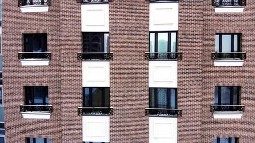 The facade of a brick building with windows