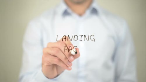 Man Writing Landing Page on Clear Surface