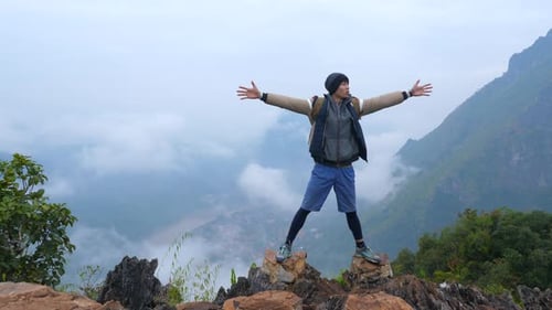 Asian Hiker Celebrating On Top Of A Mountain