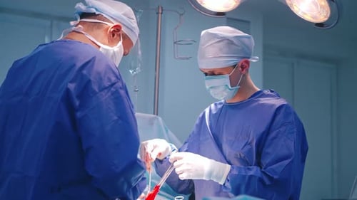 Two Surgeons Perform Operation in Operating Room