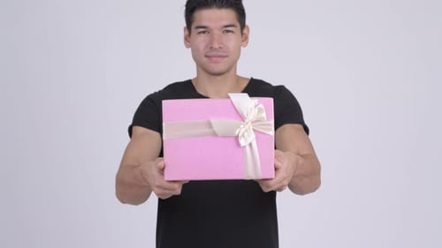 Young Adult Offers Pink Gift Box with Ribbon
