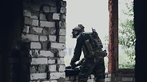 Military Man Preparing Equipment of Firearms To the Mission. Pulls Out Assault Rifle From the