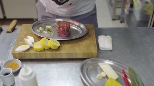 Chef Prepares Elegant Beef Dish in Restaurant Kitchen