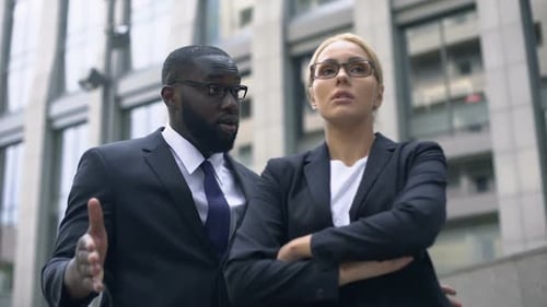 Business Colleagues Arguing in Front of an Office Building