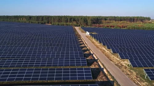 Aerial Drone Footage. Dolly Shot. Flight Over Solar Panel Farm.