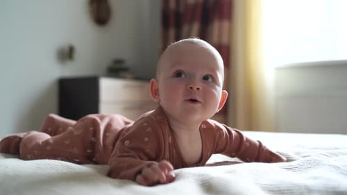 Cute Infant Lying on Tummy on Bed