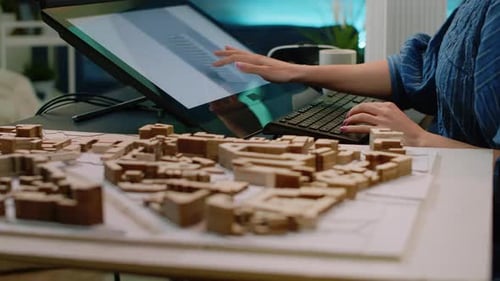 Close Up of Building Model on Table and Woman Using Touch Screen