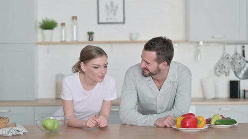 Young Adults Talk in a Bright Kitchen