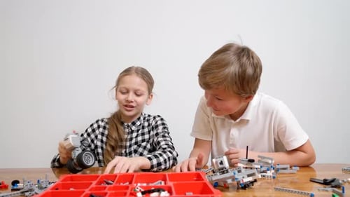 Boy and Girl Having Fun Using Building Kit