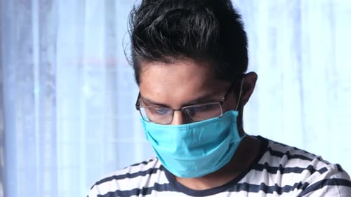 Young Adult Wearing a Blue Face Mask