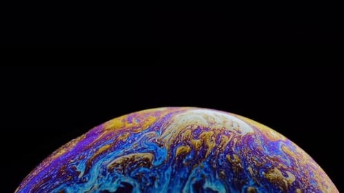Macro Shot of Iridescent Swirling Soap Bubble
