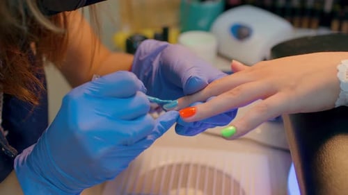 Applying Turquoise Nail Polish in a Nail Salon