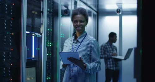 Smiling Ethnic Woman in Data Center