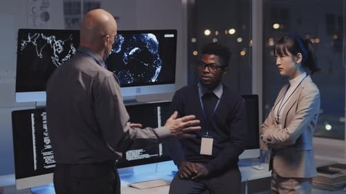 Data Science Team Discusses Programming Code at Night