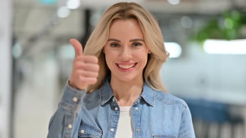 Woman Gives Thumbs Up of Approval and Success
