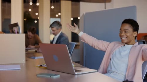 Successful Woman Celebrates Good News at Workplace