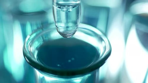 Pipette Drops Liquid into Test Tube Close-Up