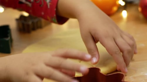 Child's Hands Making Christmas Cookies With Cutters