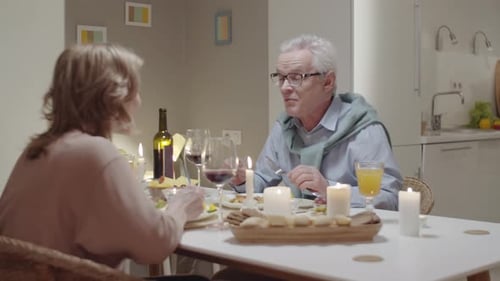 Senior Couple Enjoying Romantic Candlelit Dinner at Home