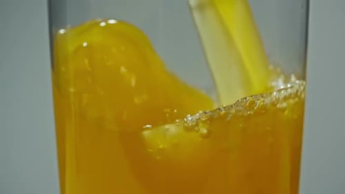 Orange Juice Poured into Glass with Ice