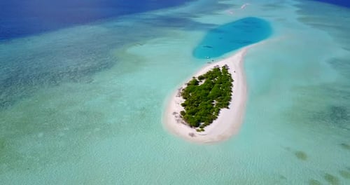 Daytime aerial tourism shot of a sunshine white sandy paradise beach and turquoise sea background in