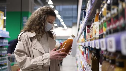 Woman Buys Juice While Wearing Mask in Grocery