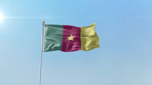 Realistic Waving Flag of Cameroon in Bright Blue Sky