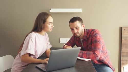 Young Couple Using Laptop Together at Home