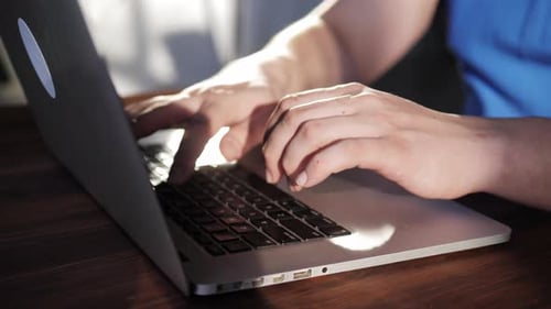 Close Up of Hands Typing on Laptop Keyboard
