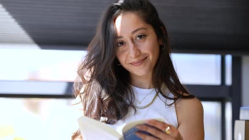 Young Girl Reading Book in Office